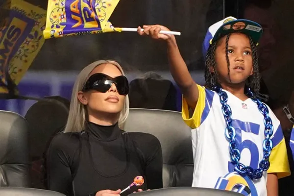 Kim Kardashian tried to cover Saint's face with her hand after he showed the middle finger to the paparazzi recently.
