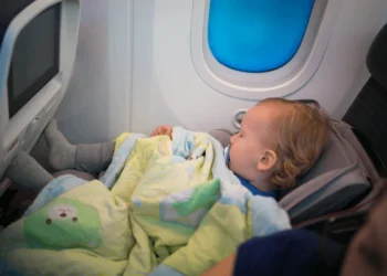 Federal officials caution against holding infants on laps during flights due to safety concerns after Alaska incident.